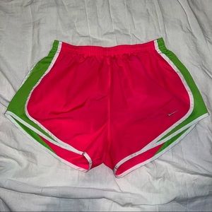 Womens Hot pink and green nike running shorts with white lining. Size medium.